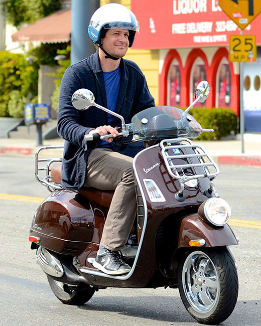 Jason Segel smiling on a scooter