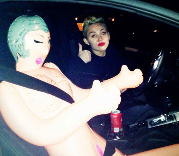 Miley Cyrus Finds a Travel Companion in a Blow Up Doll PHOTO